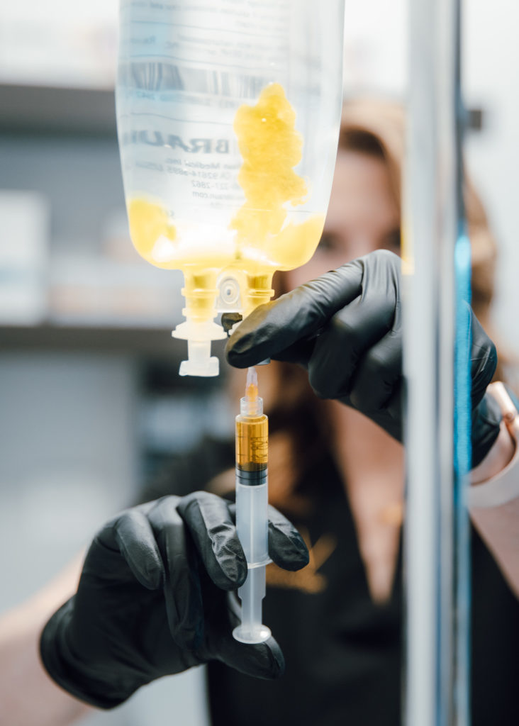 provider preparing a IV drip treatment after a HydraFacial near Naperville