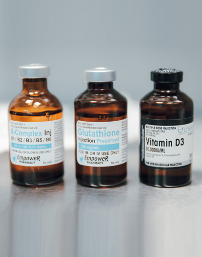 Three vials of medication labeled B-Complex, Glutathione, and Vitamin D3.