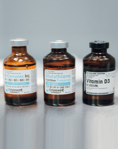 Three amber glass vials containing B-Complex, Glutathione, and Vitamin D3 injections.